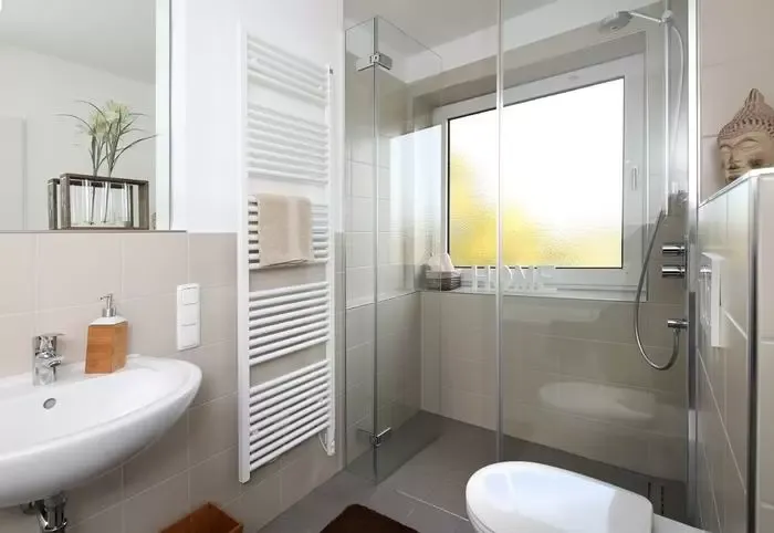 Newly fitted bathroom with walk-in shower and heated towel rail